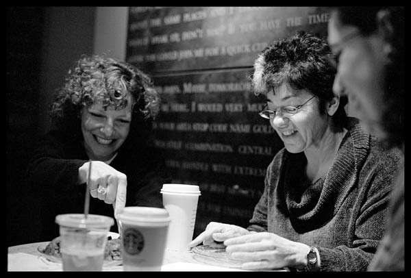 People gathered around and chatting at a coffee shop